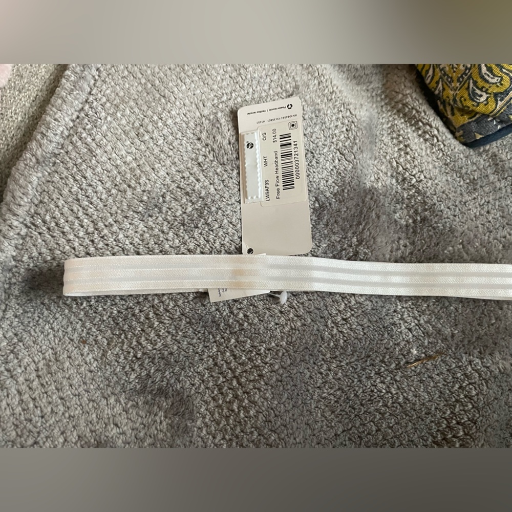 White lululemon headband with grips on the inside